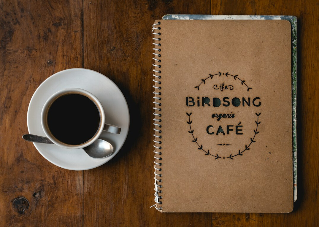 Notebook and coffee on a desk
